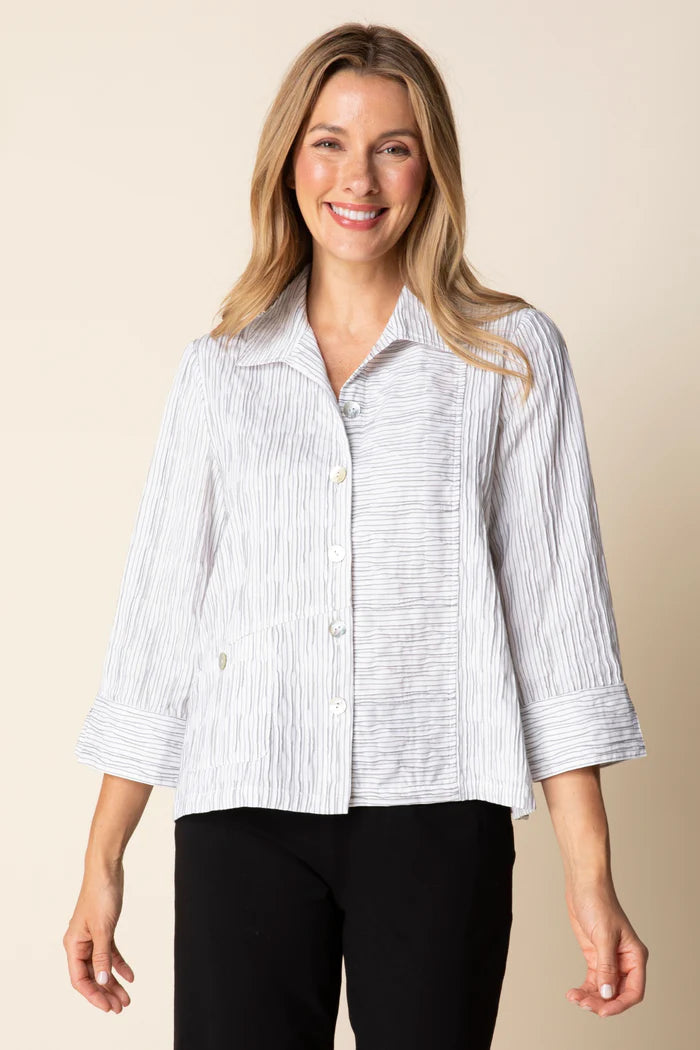Woman wearing a white and blue striped shirt against a beige background