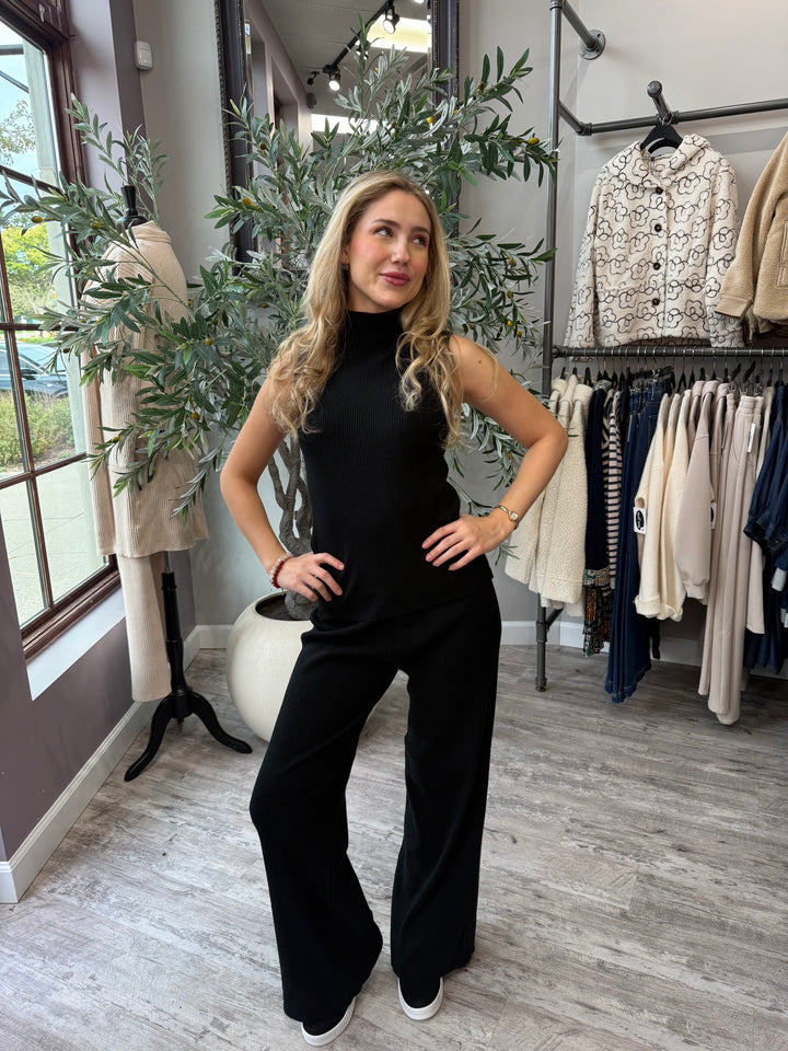 Rumi Ribbed Wide Leg Pant in black styled with matching sleeveless mock neck top, full-length front view