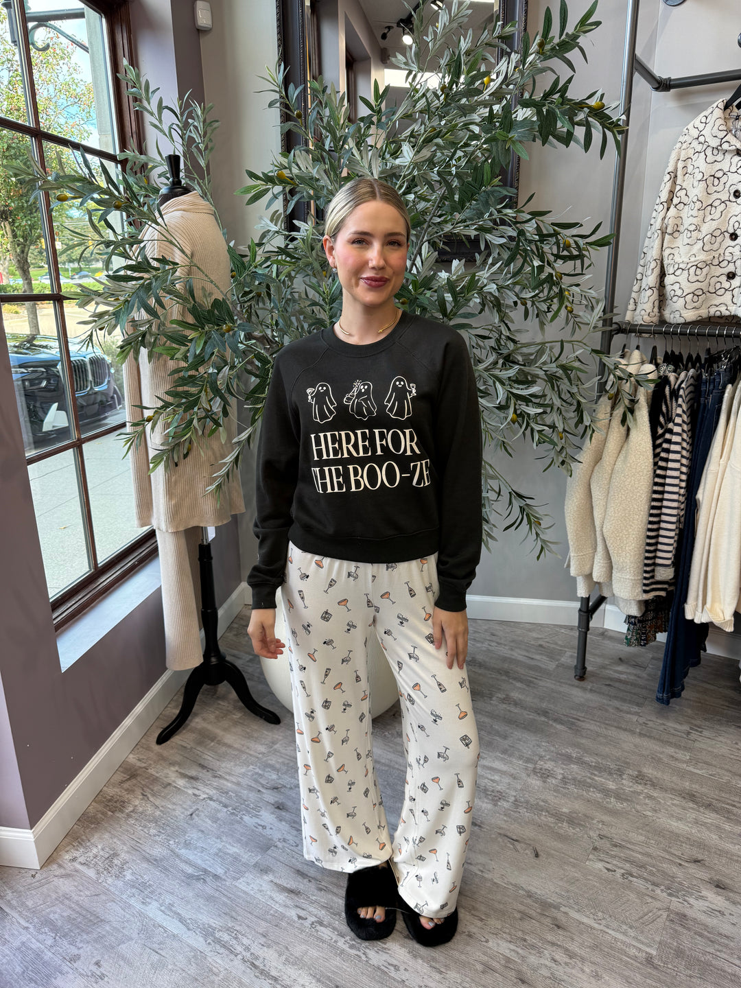 Here for the Boo-ze Sweatshirt in black, full-length front view styled with cocktail print pajama pants