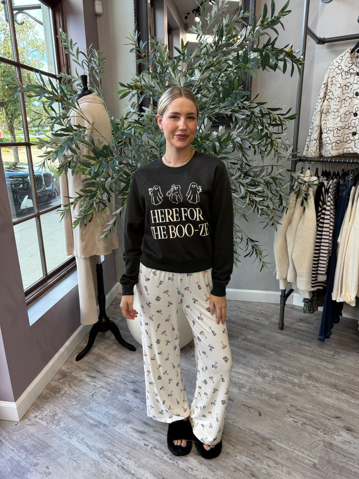 Here for the Boo-ze Sweatshirt in black, full-length front view styled with cocktail print pajama pants