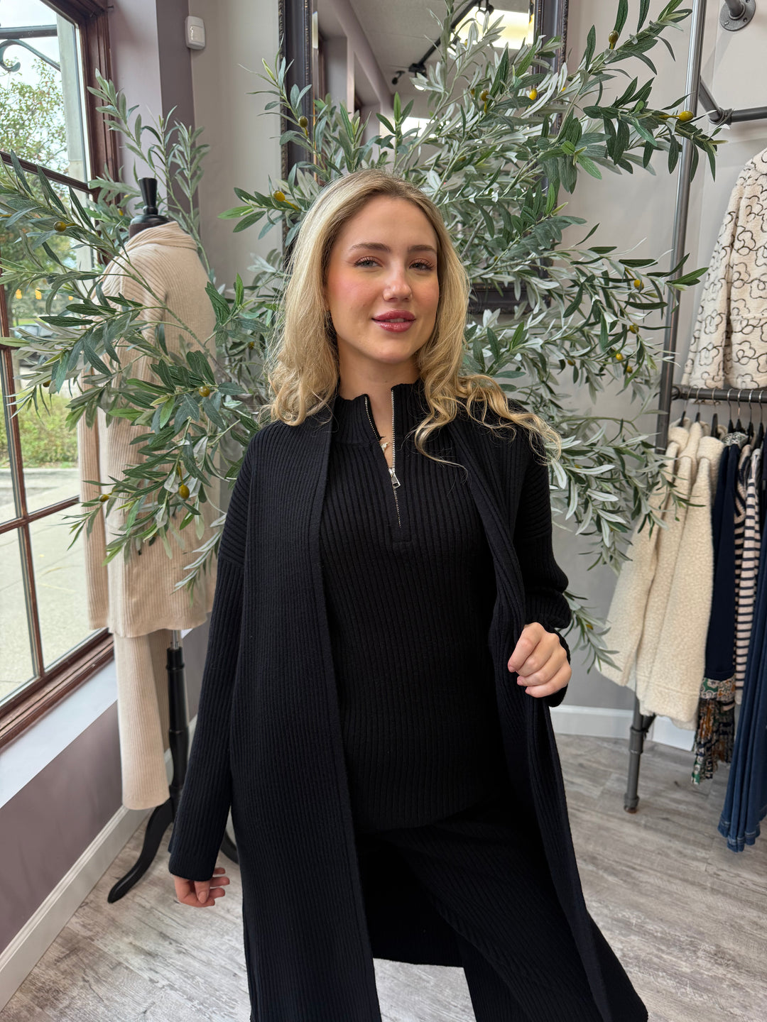 St. Moritz Ribbed Open Cardigan in black, long open-front duster styled over matching zip mock neck tank, front view