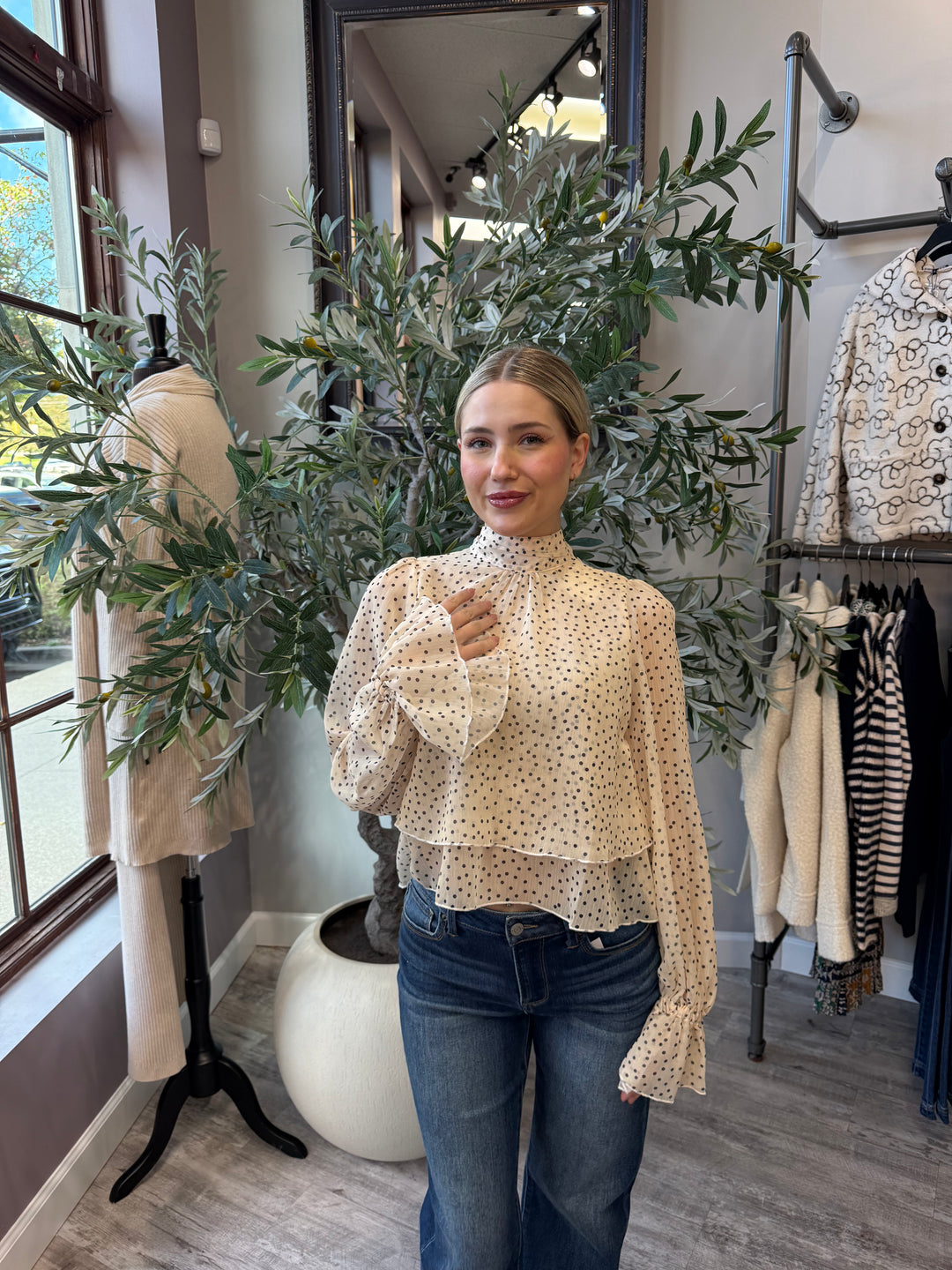 Juliette Polka Dot Blouse in cream and black dots with layered hem, front view styled with jeans