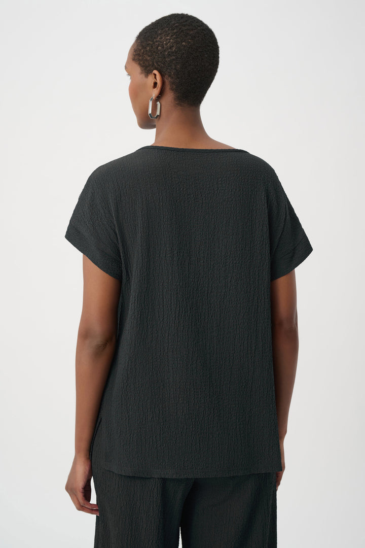 Person wearing a black t-shirt and pants on a white background