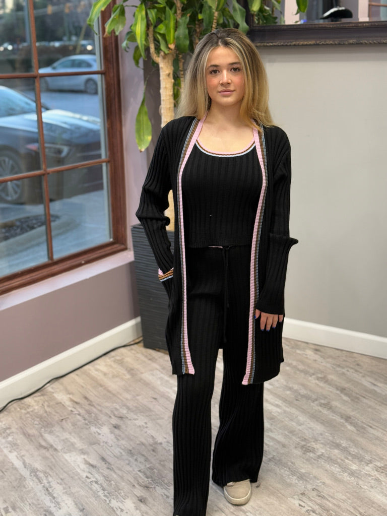 Women's ribbed lounge set in black, featuring a long cardigan with lavender trim, a cropped tank top, and matching wide-leg pants. Perfect for cozy, stylish relaxation.