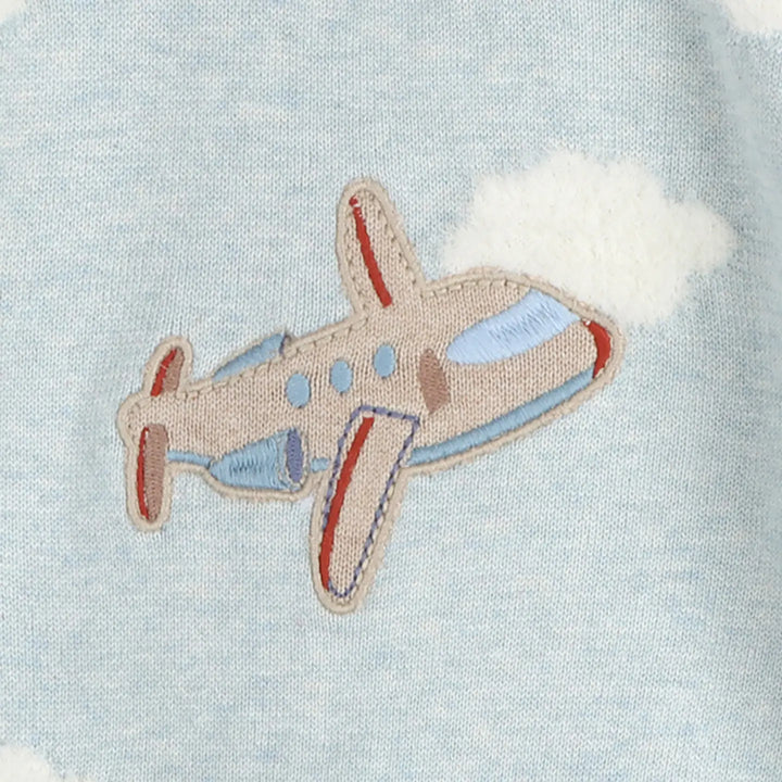 Embroidered airplane patch on a light blue fabric background