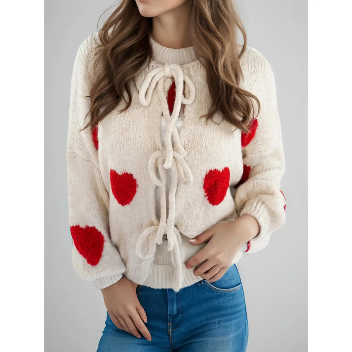 Cream tie front sweater with red hearts.