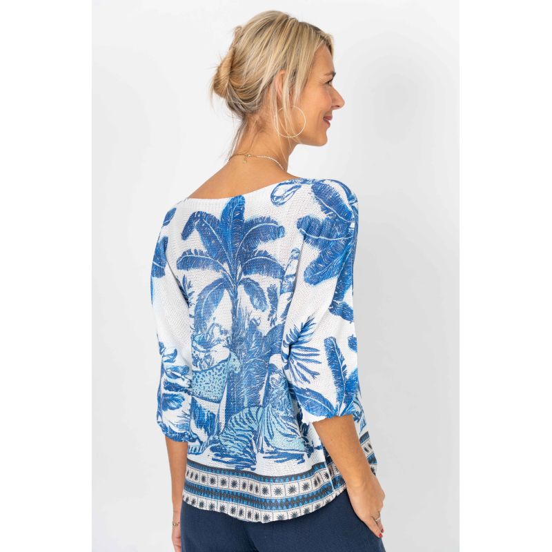 Woman wearing a blue and white patterned top on a white background