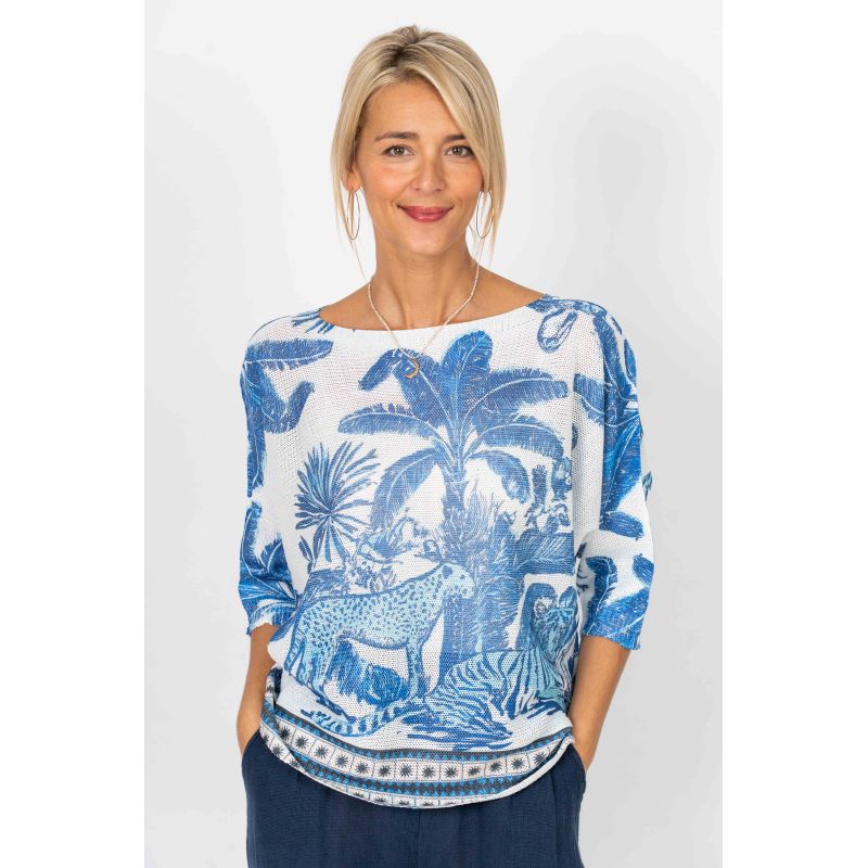 Woman wearing a blue and white patterned top on a plain background