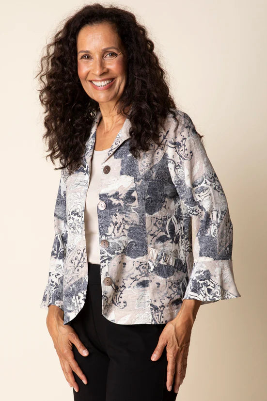 Woman wearing a patterned jacket against a plain background