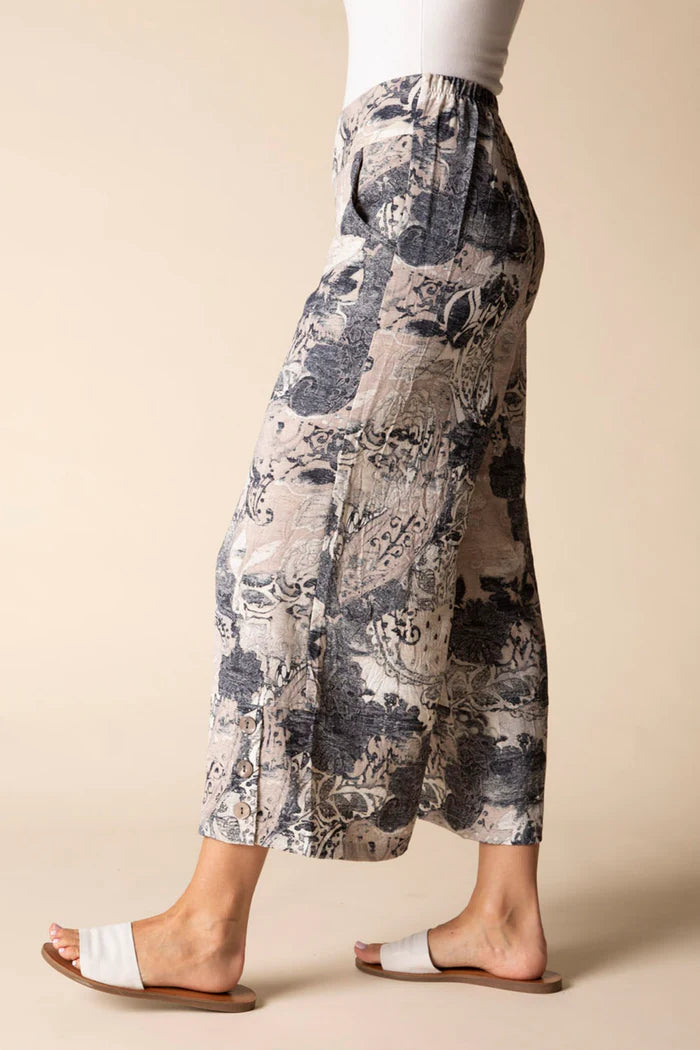 Person wearing a patterned pants with a plain background
