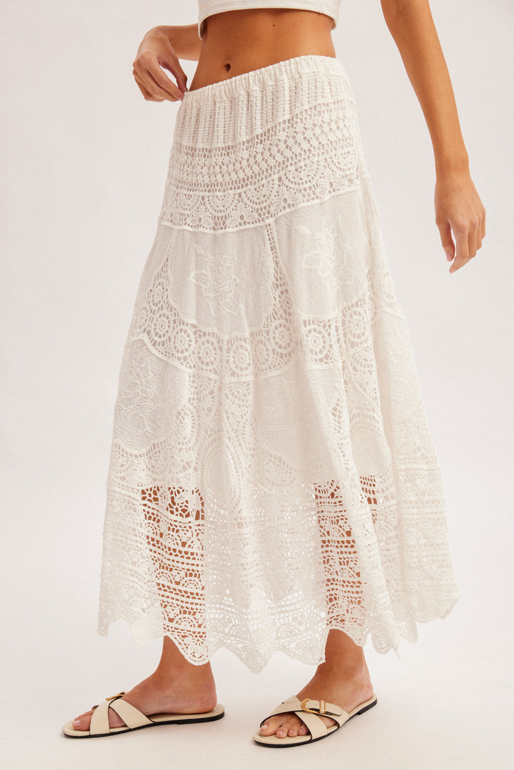 White lace skirt worn by a person on a white background
