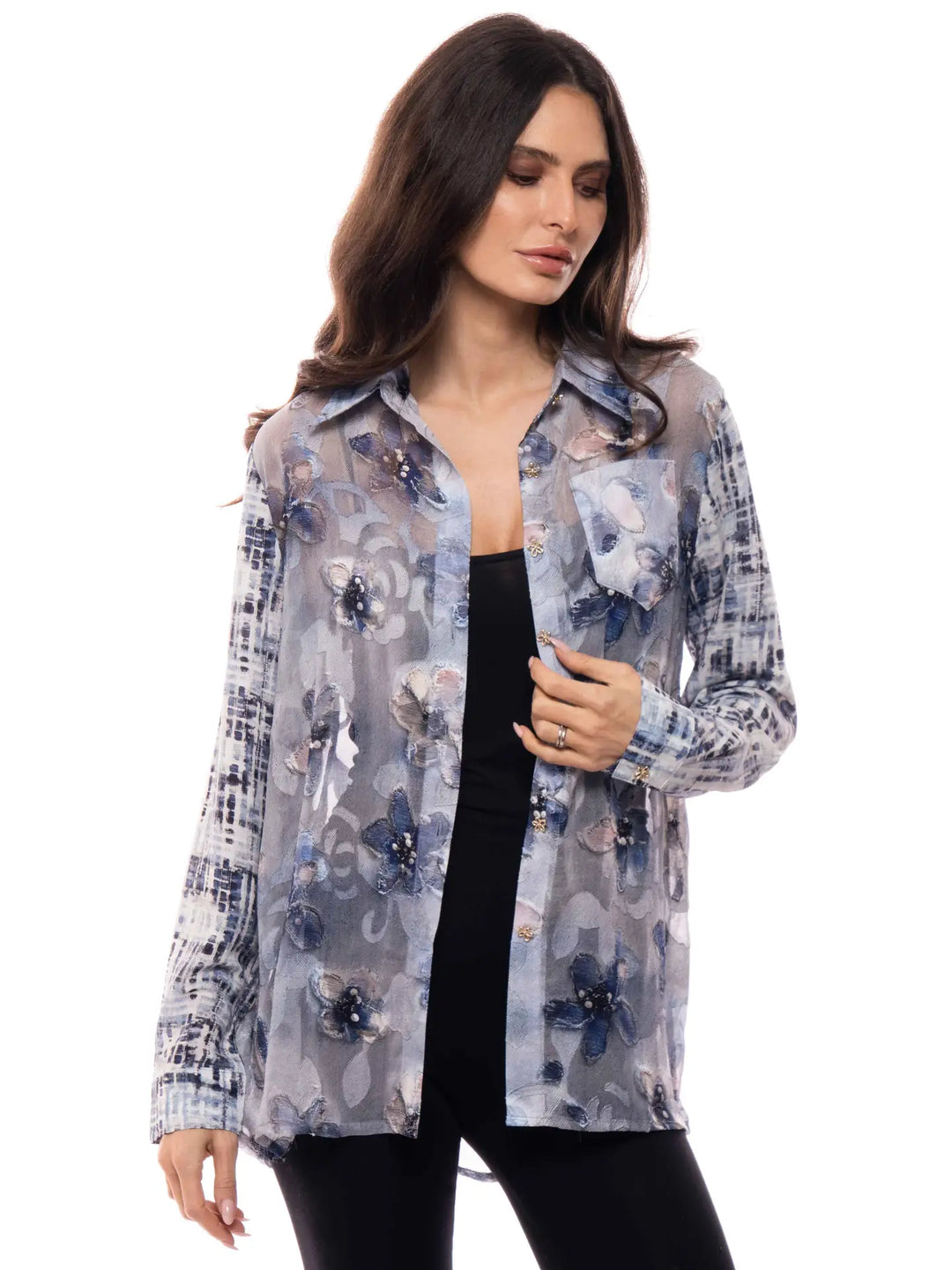 Woman wearing a floral patterned shirt on a white background