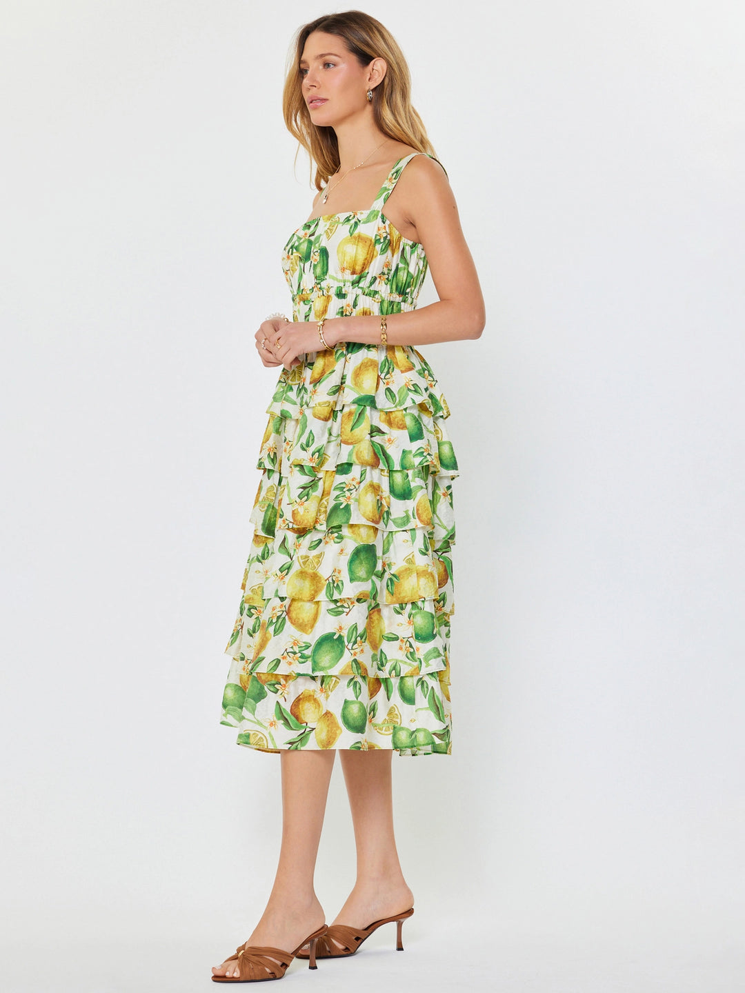Woman wearing a dress with lemon print on a white background