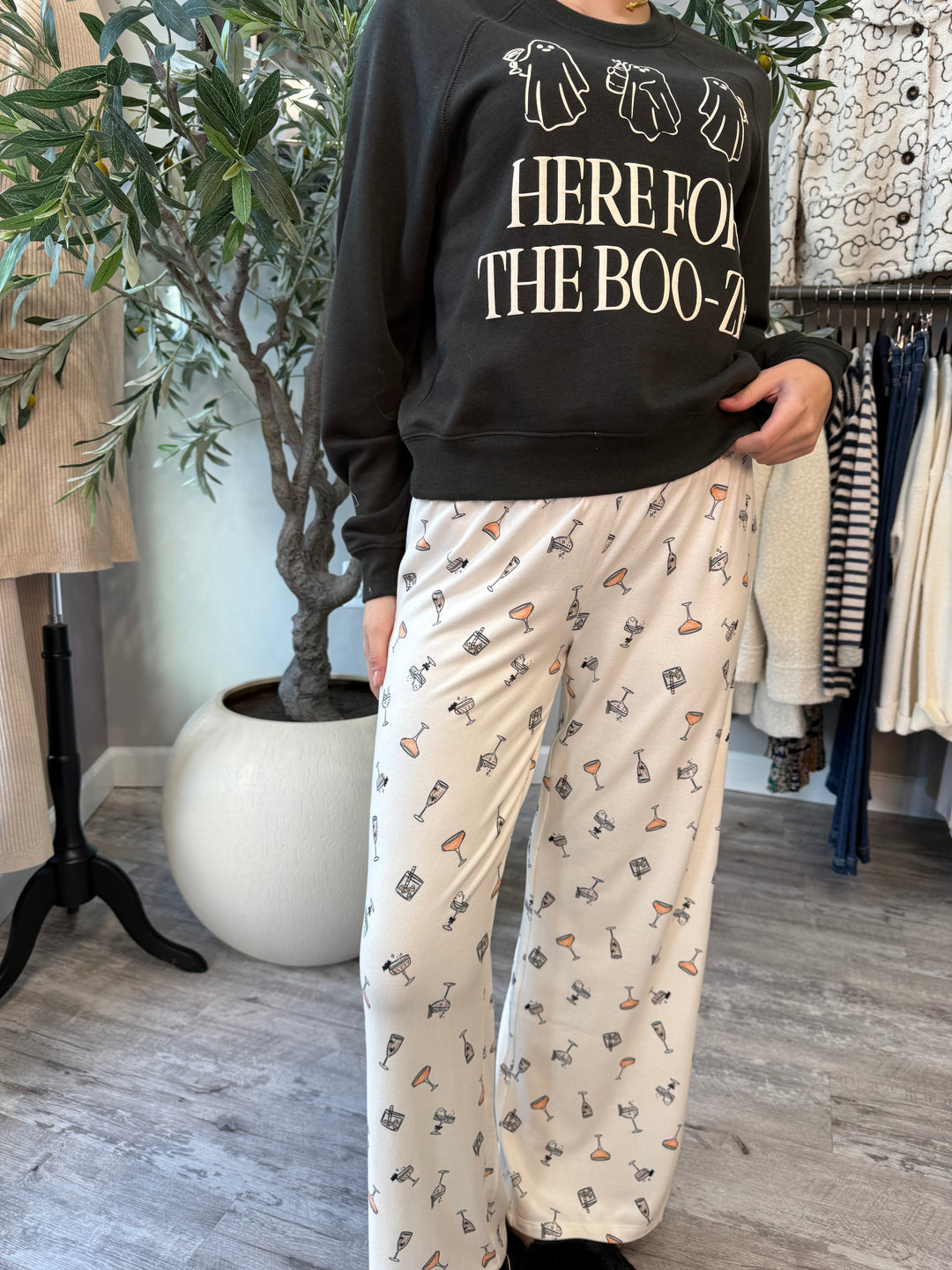 Boo-zy Pajama Pants in ivory with cocktail glass print, front view styled with black sweatshirt