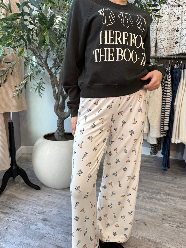 Boo-zy Pajama Pants in ivory with cocktail glass print, front view styled with black sweatshirt