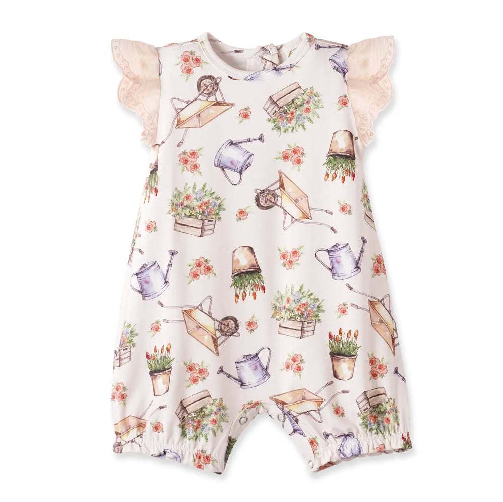 Children's dress with gardening-themed print on a white background