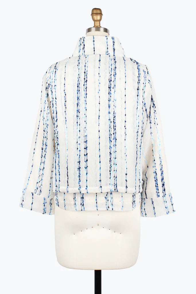 White blouse with blue pattern on a mannequin against a white background