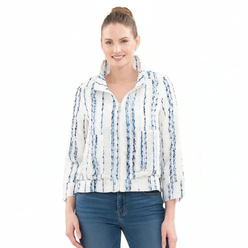 Woman wearing a white jacket with blue patterns on a white background