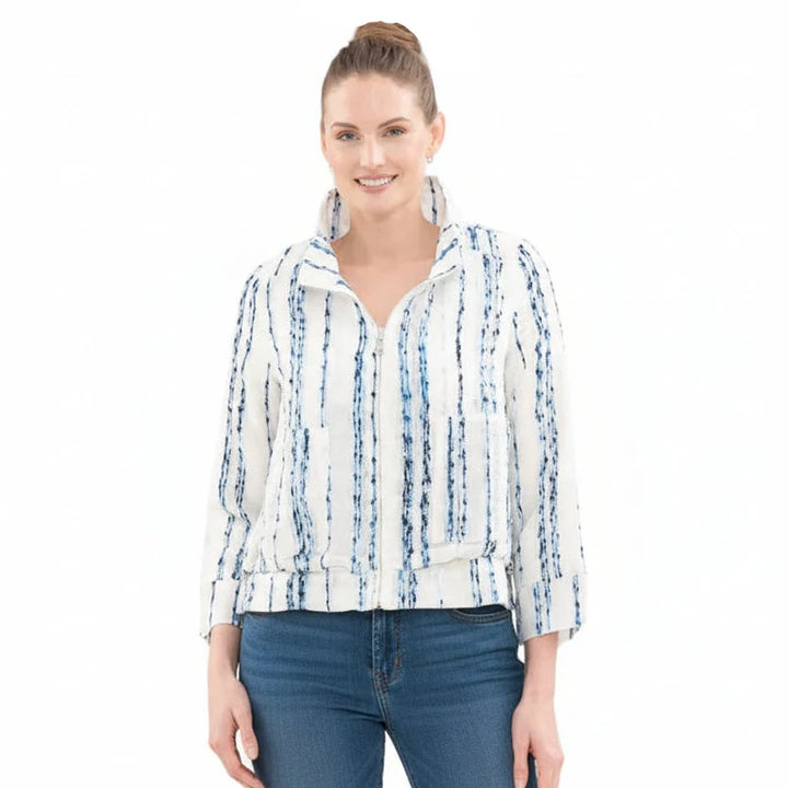 Woman wearing a white jacket with blue patterns on a white background