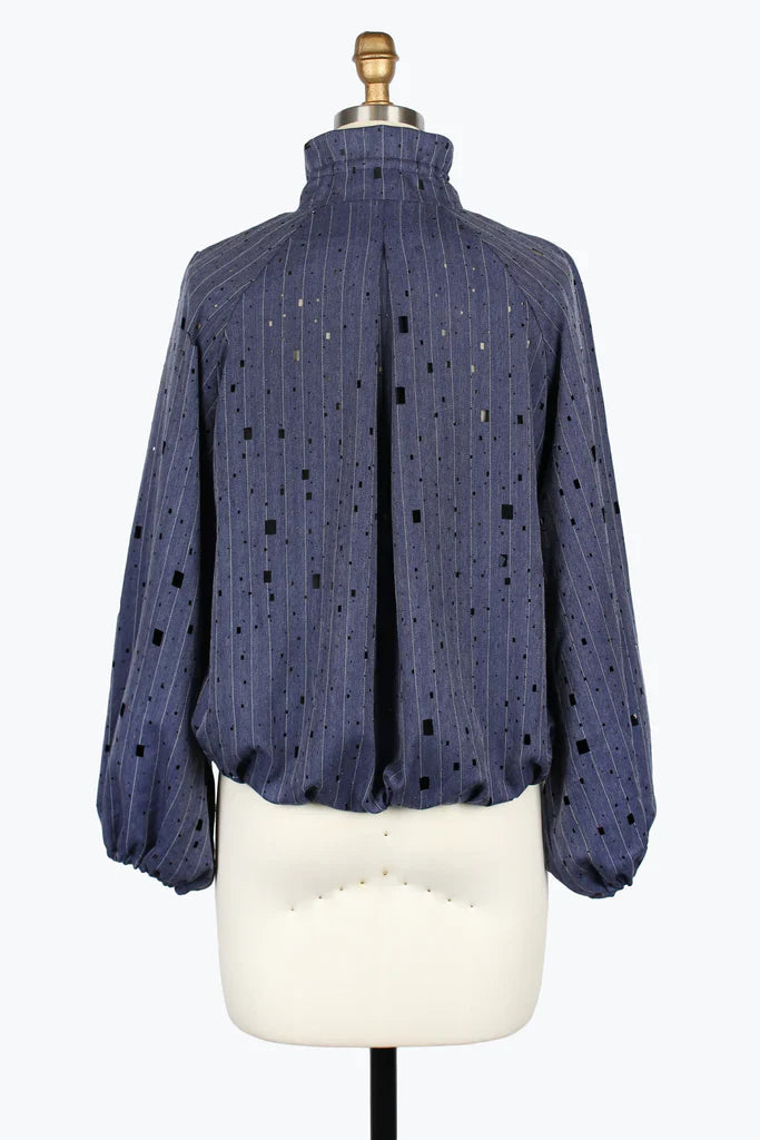 Blue textured blouse on a mannequin against a white background