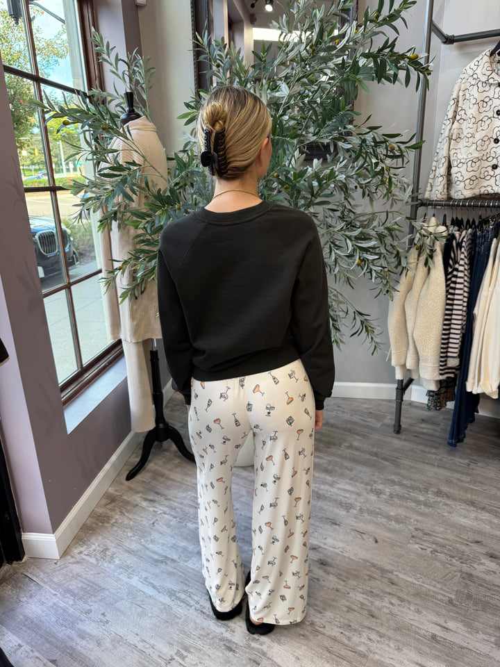Boo-zy Pajama Pants back view in ivory cocktail print, styled with black Here for the Boo-ze Sweatshirt