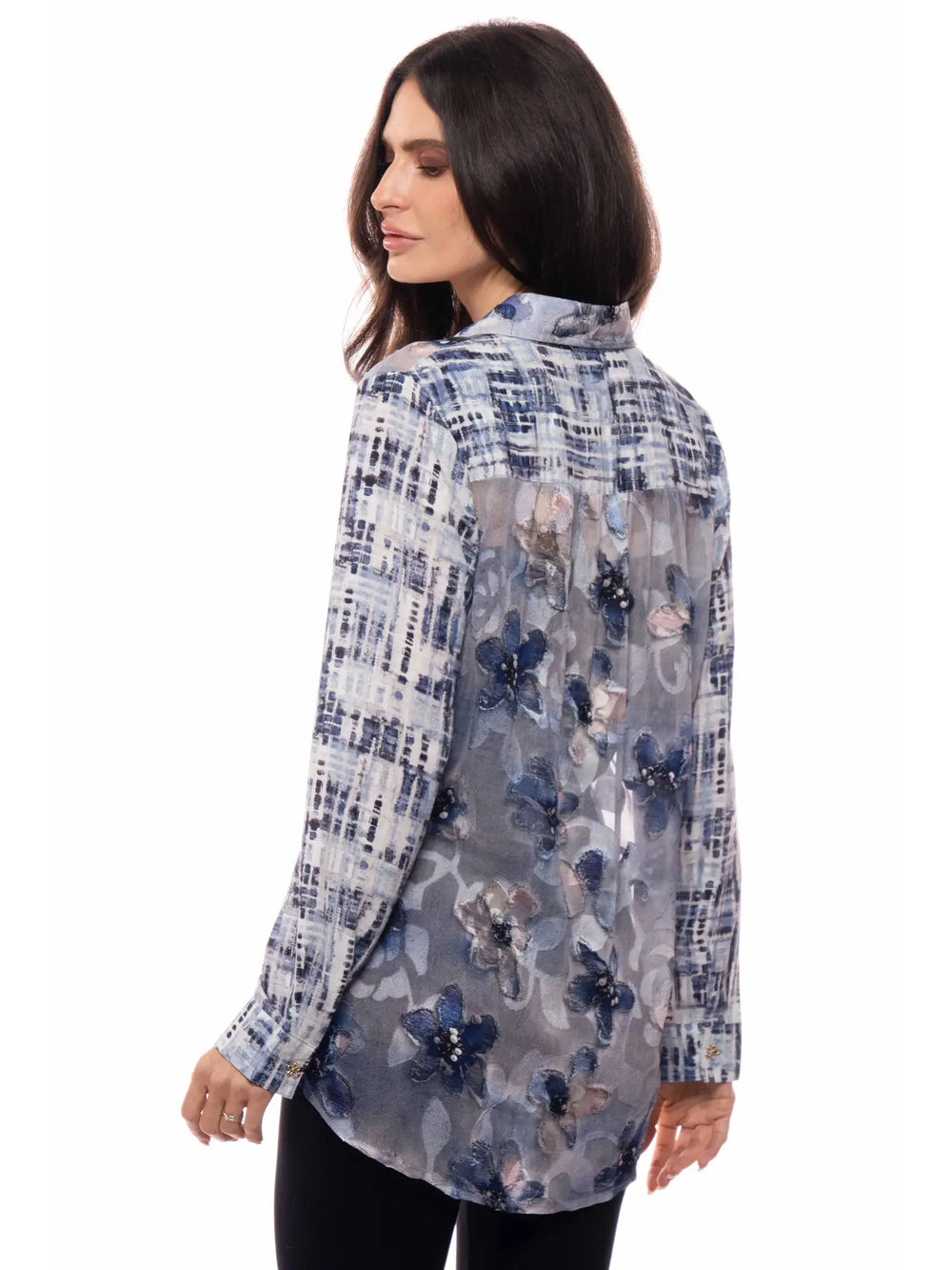 Woman wearing a floral and checkered long-sleeve shirt on a white background