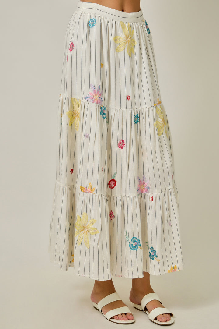 Striped skirt with floral embroidery on a plain background