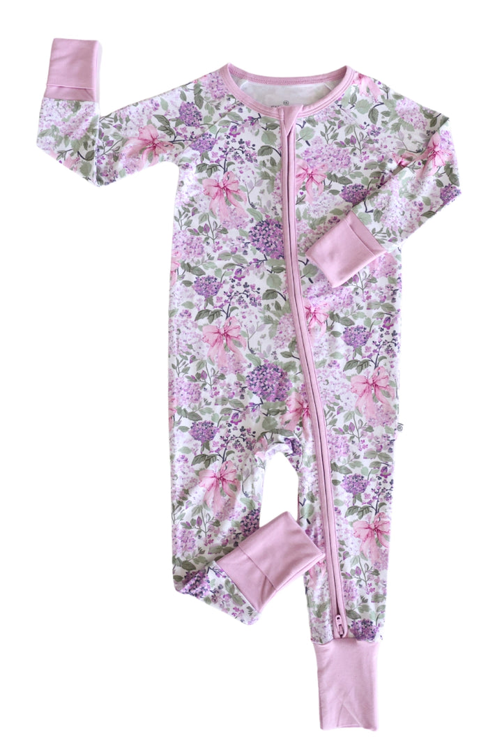 Floral patterned baby onesie with pink accents on a white background