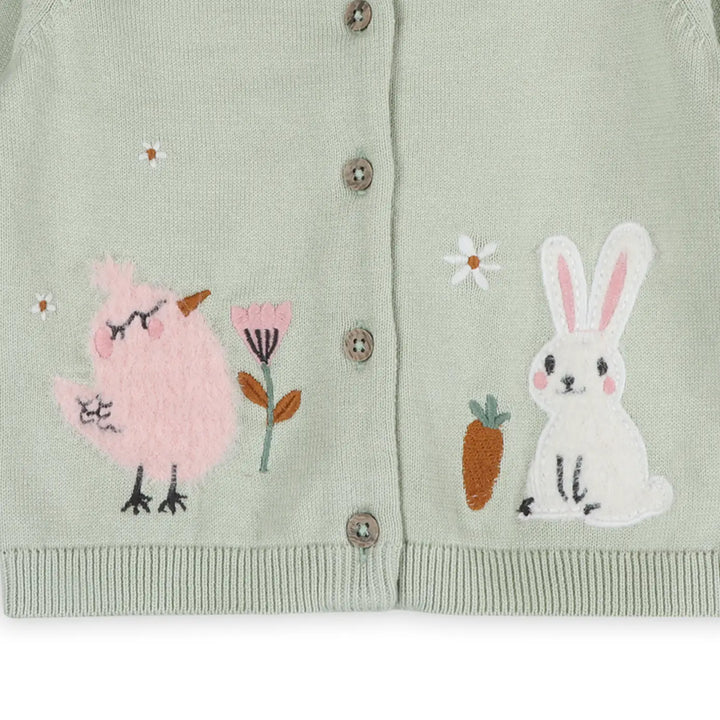 Light green cardigan with embroidered bird, flower, carrot, and rabbit design on a white background
