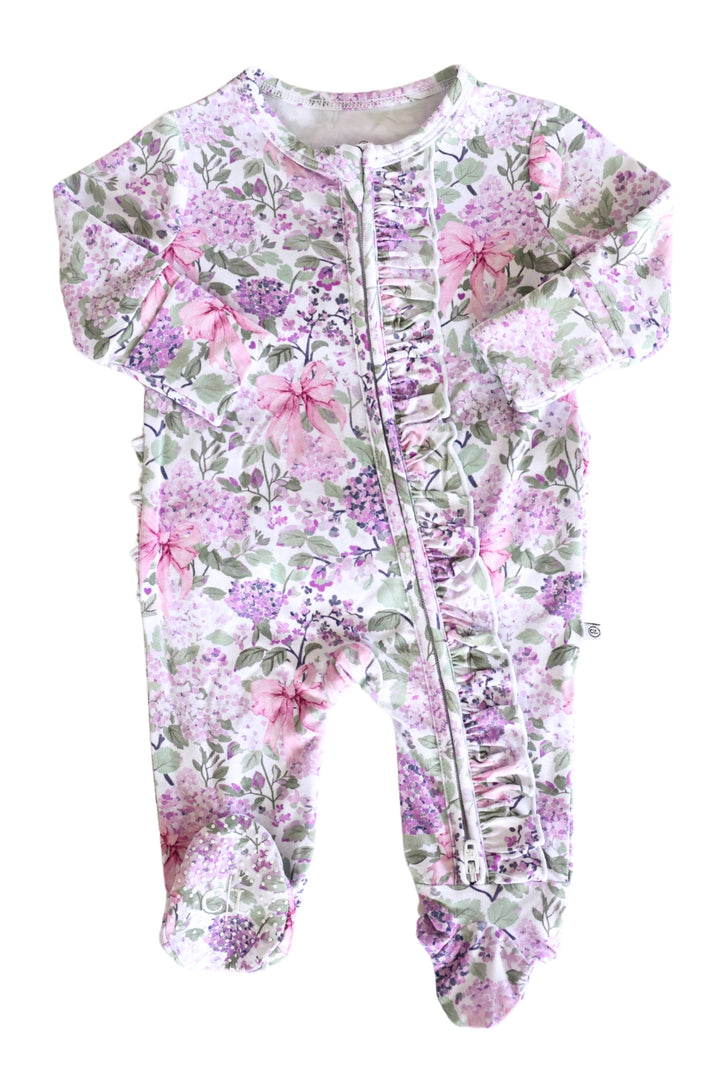 Floral patterned baby onesie with a zipper on a white background