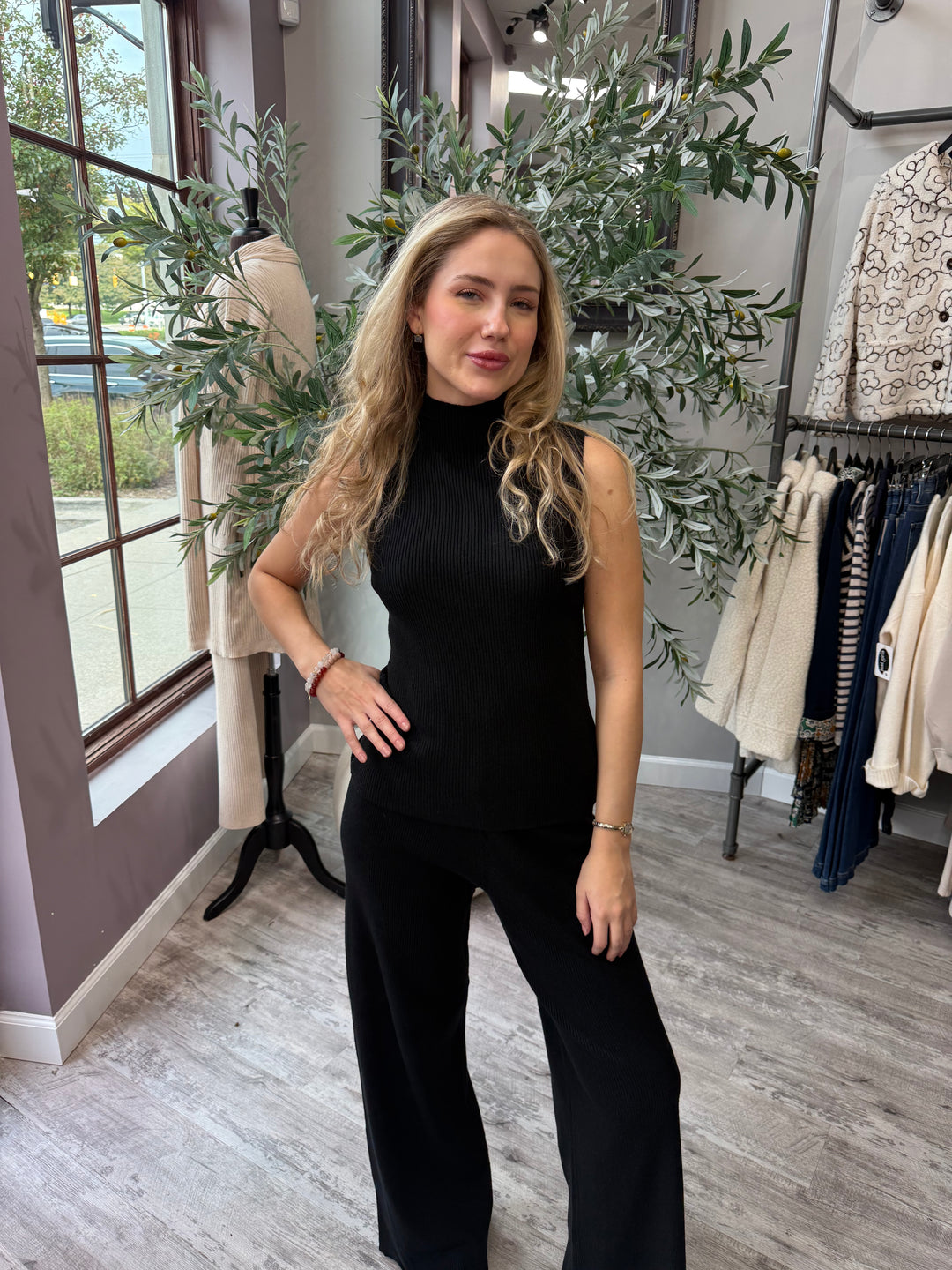 Rumi Ribbed Wide Leg Pant in black styled with sleeveless mock neck top, front view