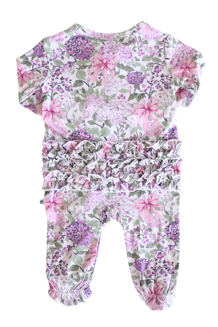 Floral patterned baby romper on a white background