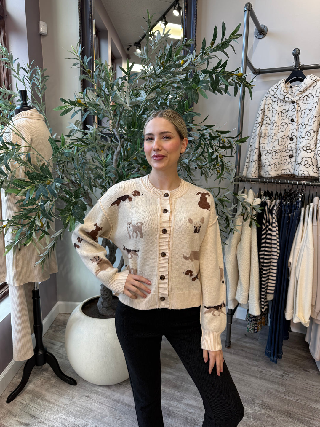 Best in Show Cardigan in cream with dog motifs and contrast buttons, waist-up front view