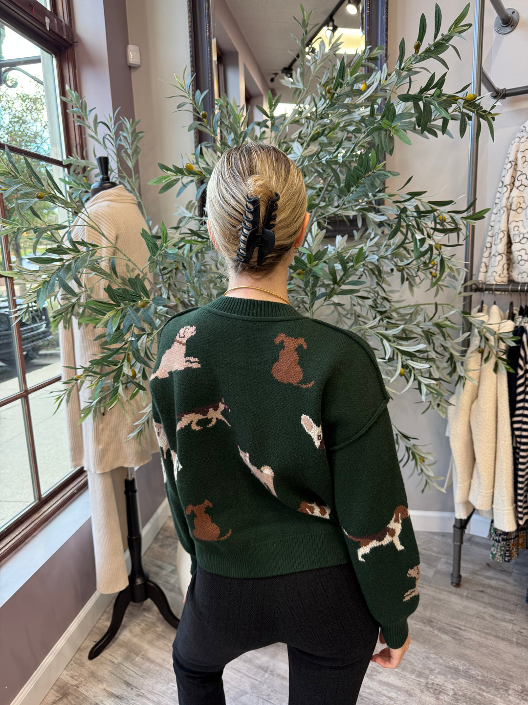 Best in Show Cardigan back view in pine green showing dog motifs across back and sleeves