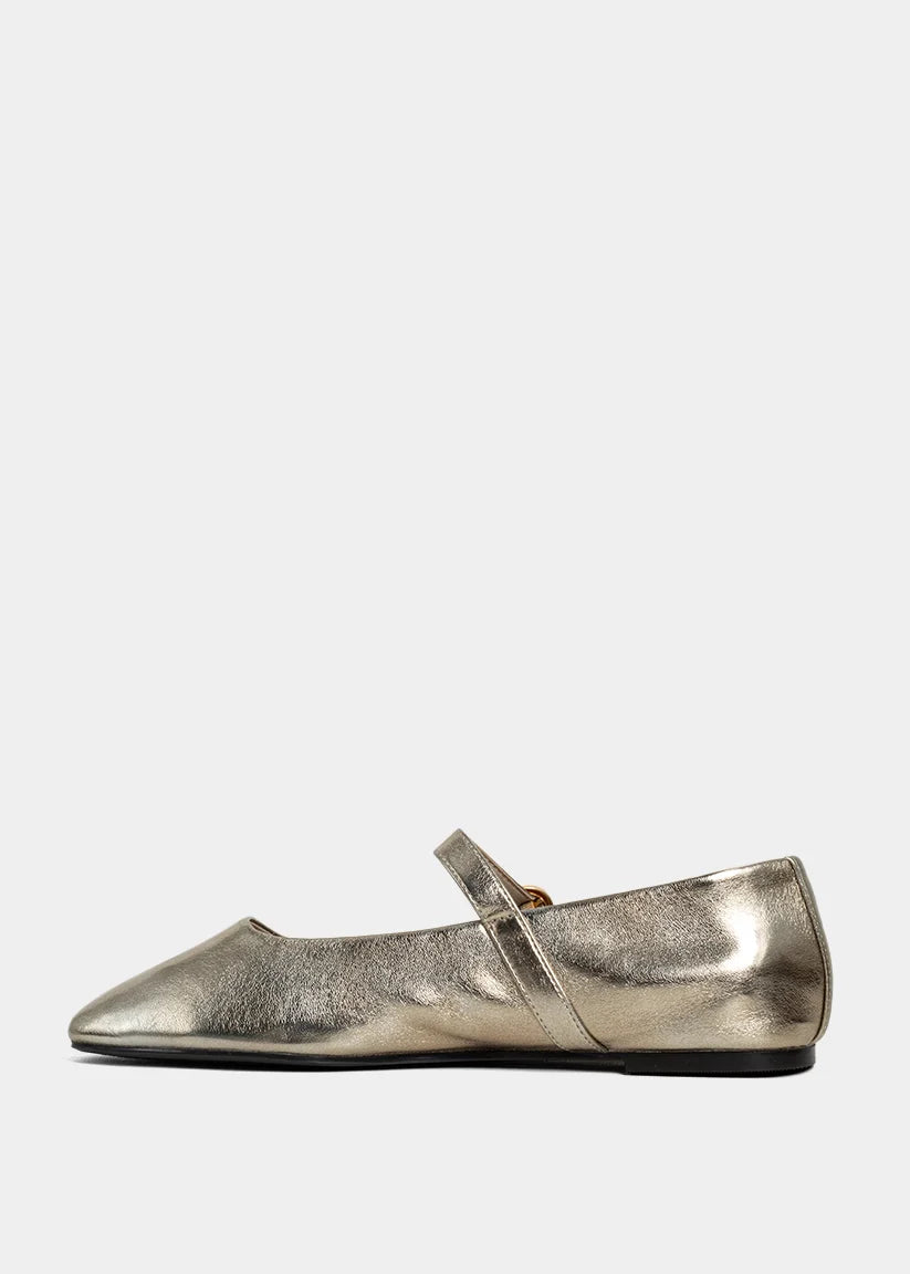 Gold metallic flat shoe on a white background