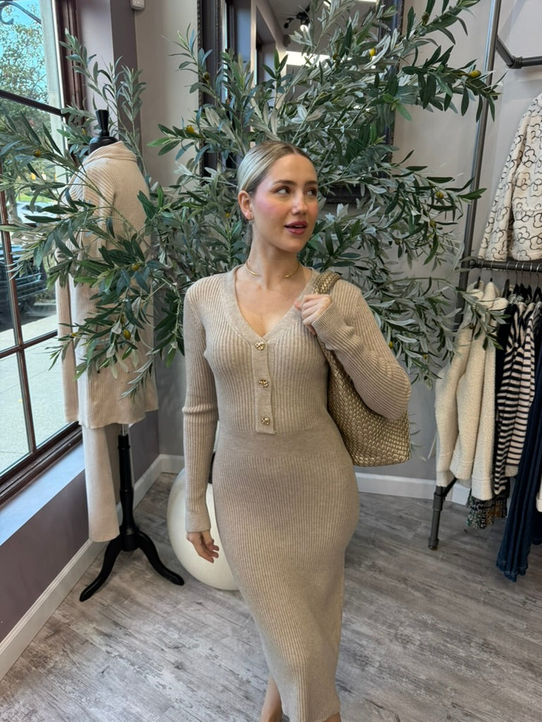 Rory Ribbed Sweater Dress in beige with V-neck and gold button placket, front view styled with woven tote