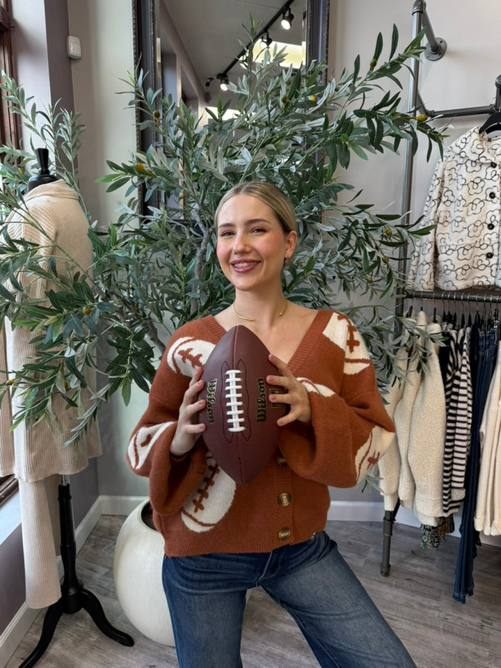 Tailgate Cardigan in rust with cream football motifs, front view