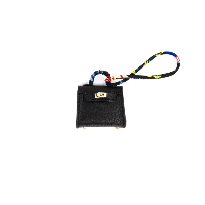 Black mini bag with colorful strap on a white background
