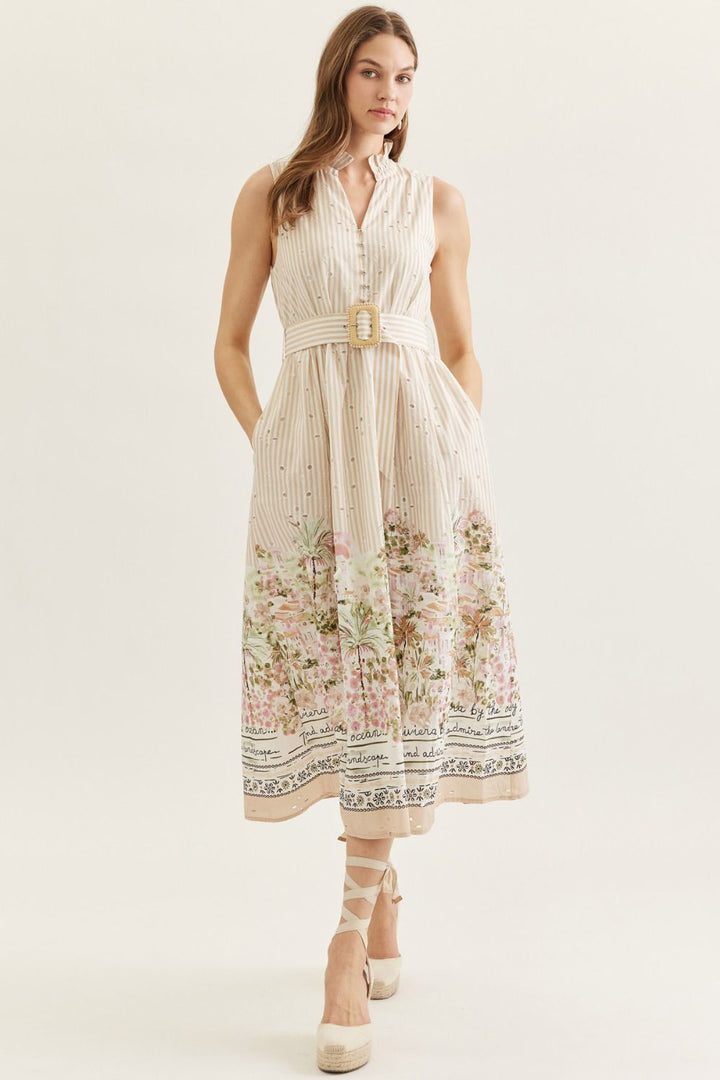 Woman wearing a floral dress with a belt on a white background