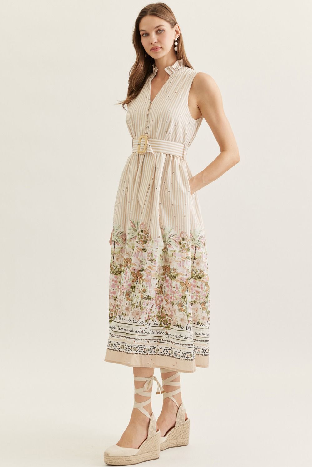 Woman wearing a sleeveless dress with floral pattern on a white background