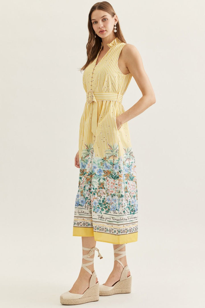 Woman wearing a yellow dress with floral pattern on a white background