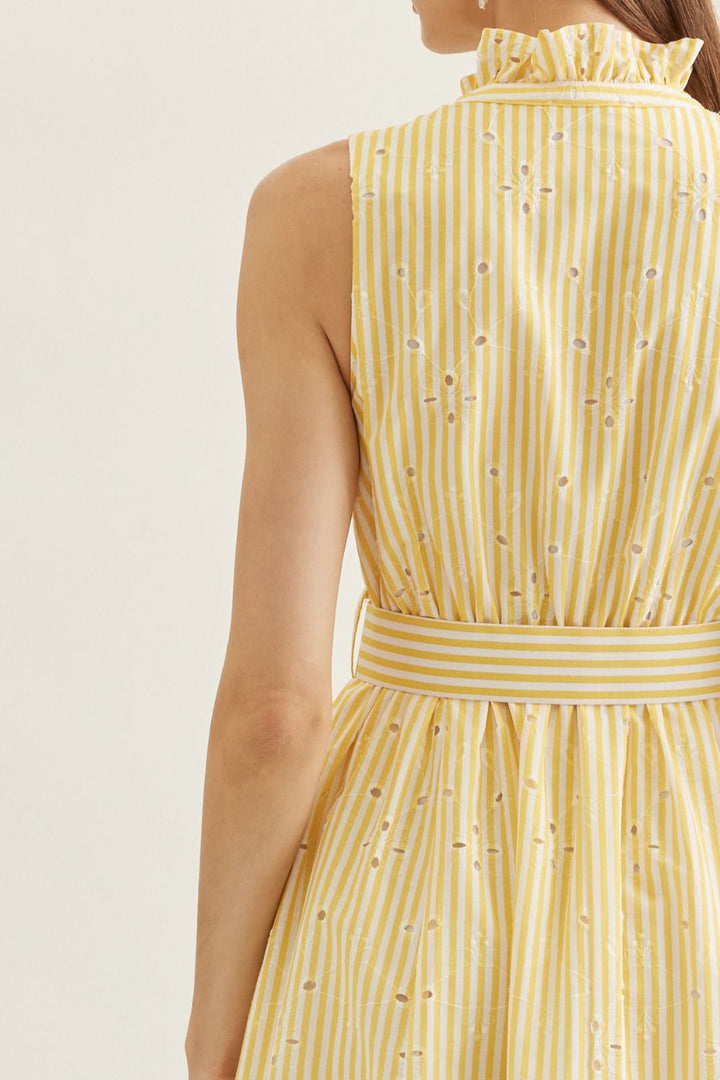 Yellow striped dress with a belt on a plain background