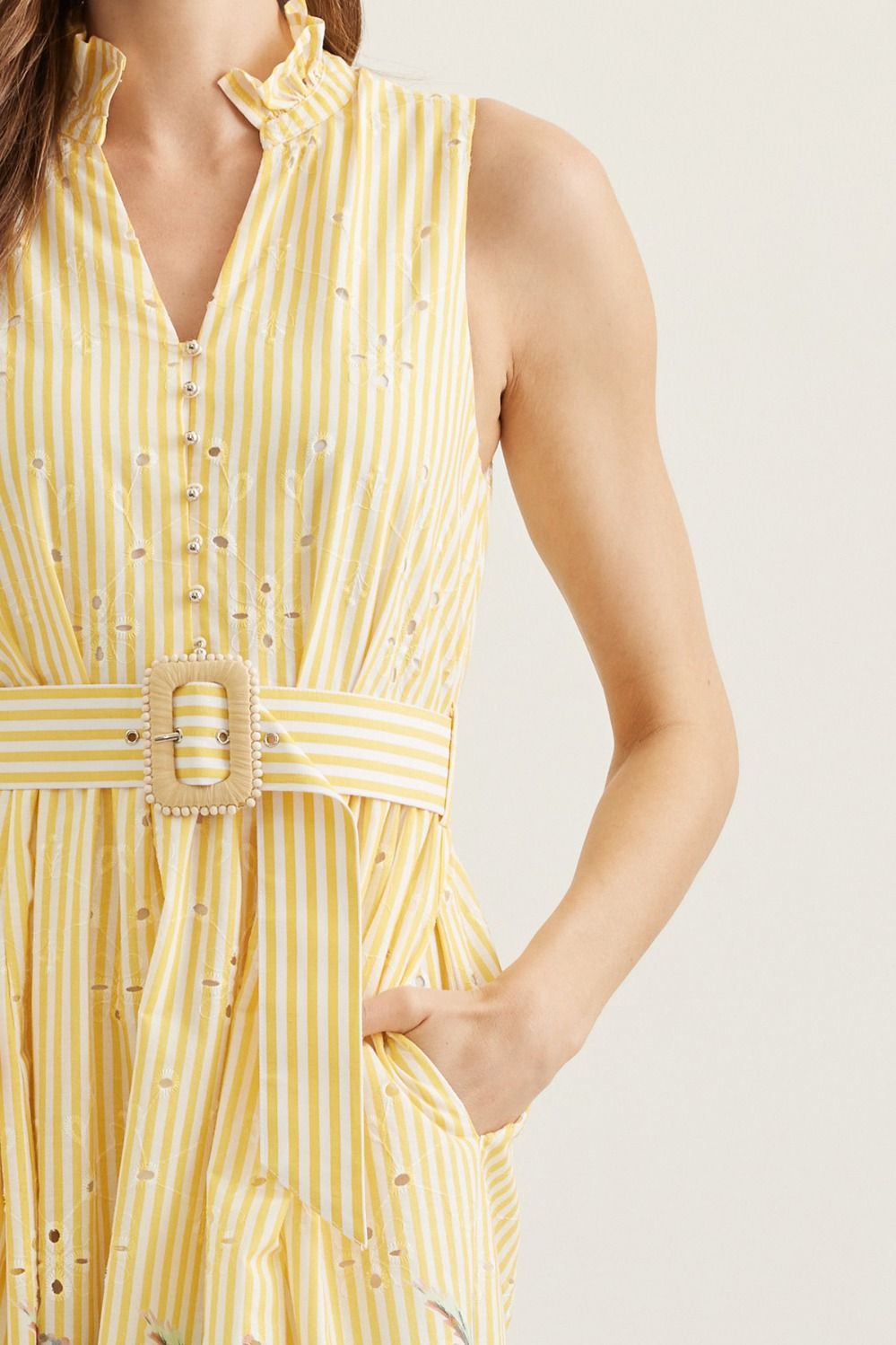 Yellow striped dress with a belt on a plain background