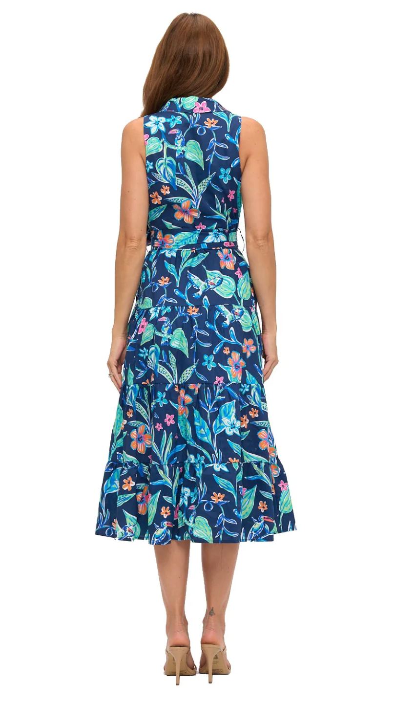 Woman wearing a sleeveless floral dress with a blue background