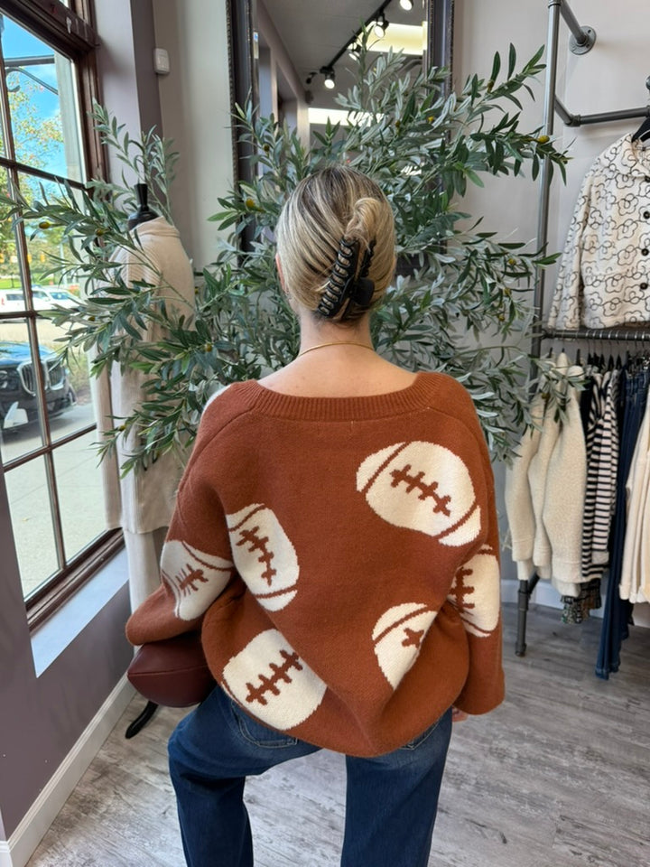 Tailgate Cardigan back view with cream football motifs on back and sleeves