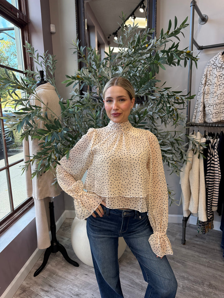 Juliette Polka Dot Blouse in cream with black dots, mock neck and ruffled cuffs, front view