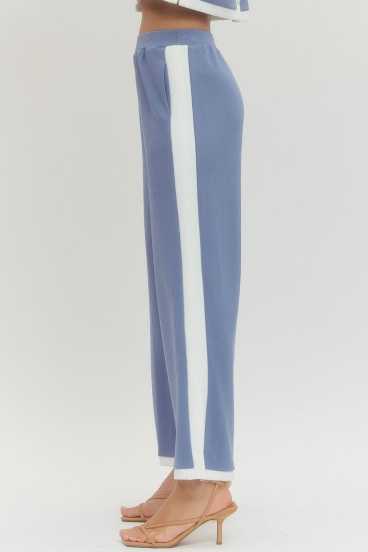 Blue pants with white stripes on a light gray background