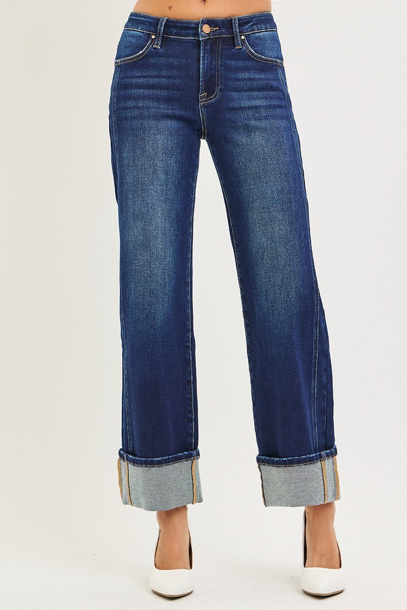 Blue jeans with rolled-up cuffs on a white background