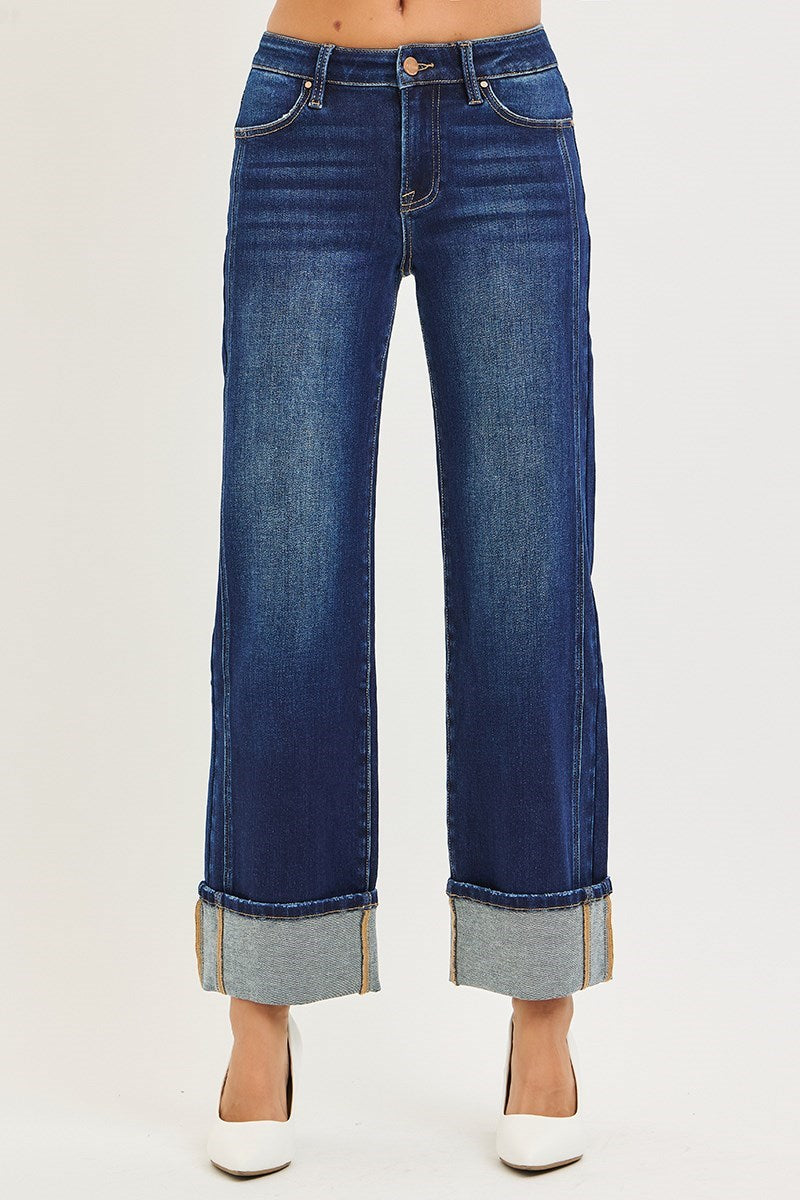 Blue jeans with rolled-up cuffs on a white background