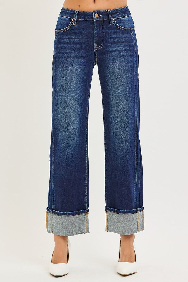 Blue jeans with rolled-up cuffs on a white background